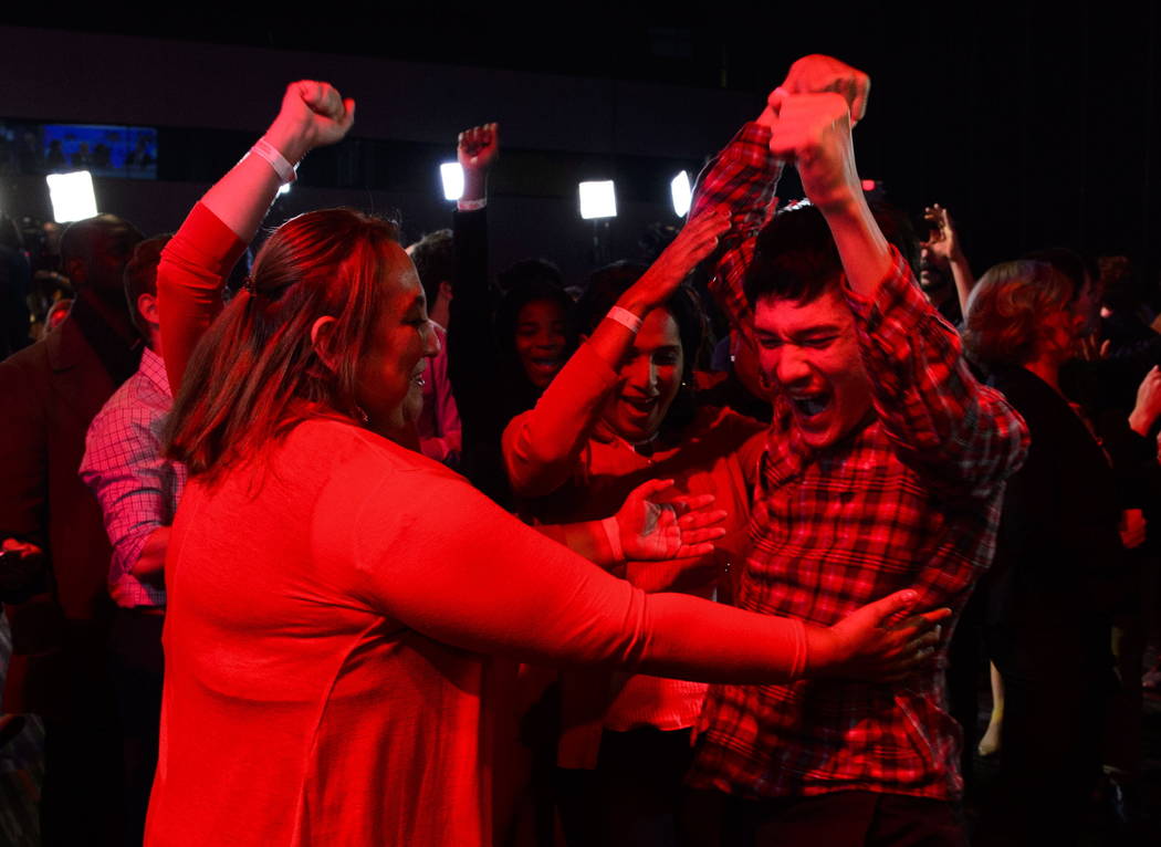 Liberal supporters react as poll numbers come in at Liberal election headquarters in Montreal o ...
