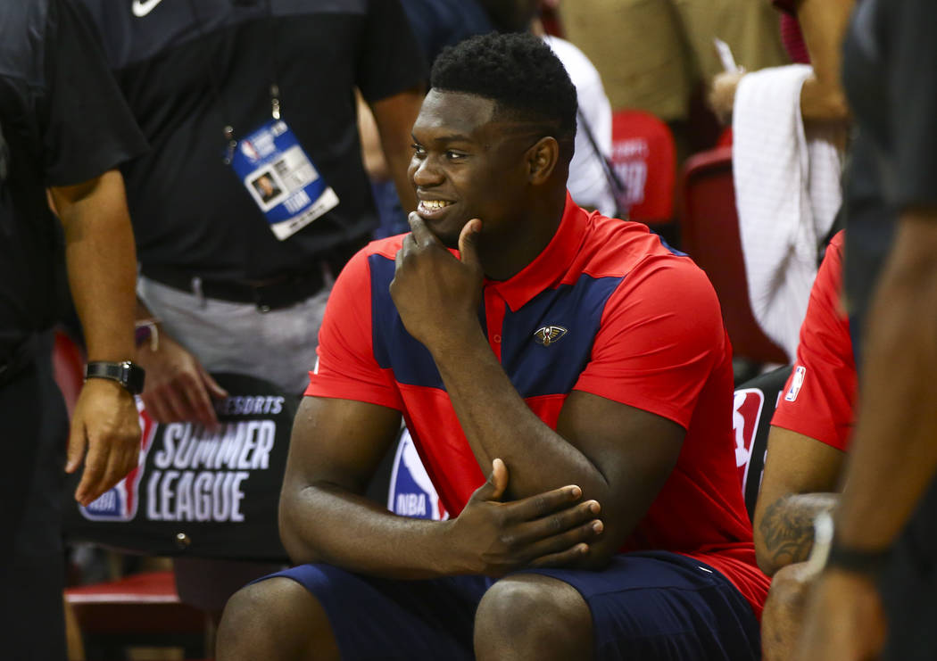 New Orleans Pelicans' Zion Williamson sits on the bench before the start of a game between the ...