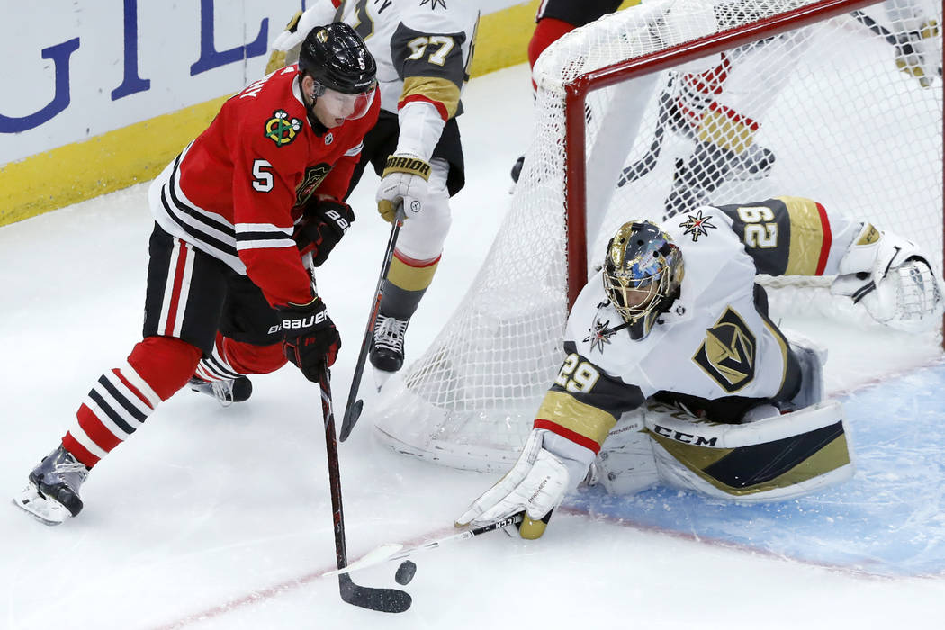 Vegas Golden Knights goaltender Marc-Andre Fleury (29) poke-checks the puck away from Chicago B ...