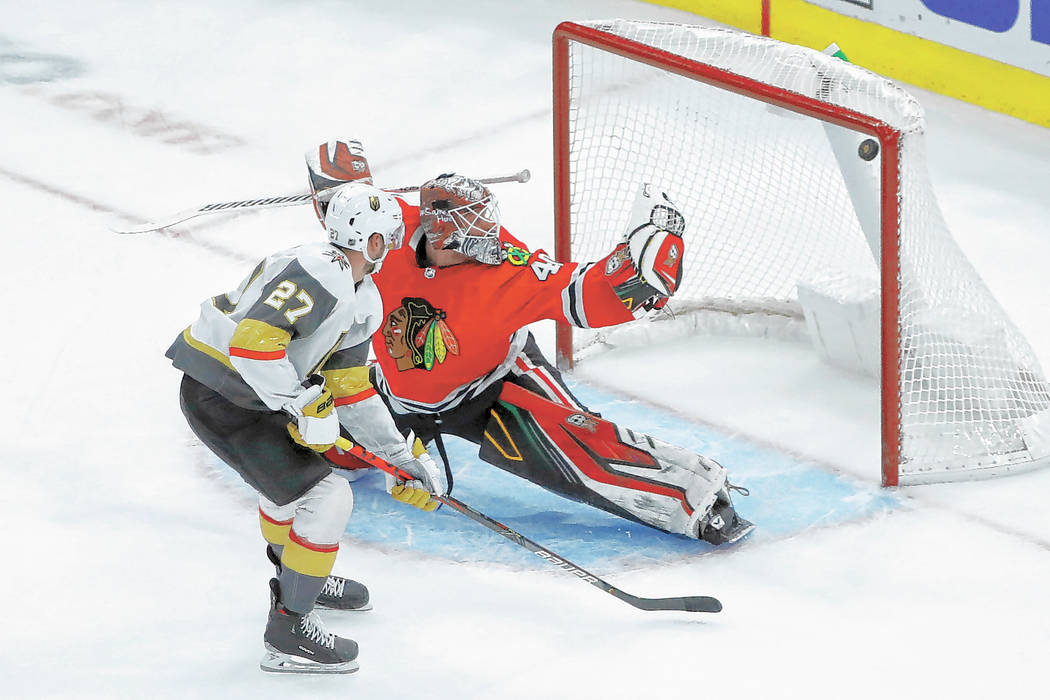 Vegas Golden Knights defenseman Shea Theodore (27) scores past Chicago Blackhawks goaltender Ro ...