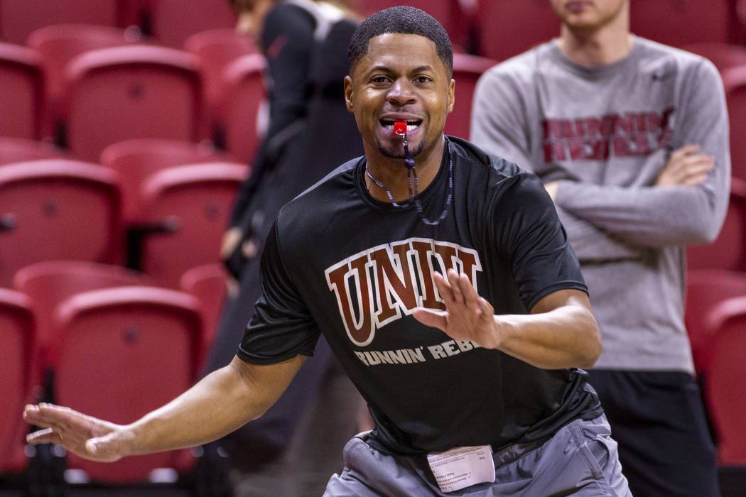 UNLV basketball assistant DeMarlo Slocum works the court as his players practice in the Thomas ...