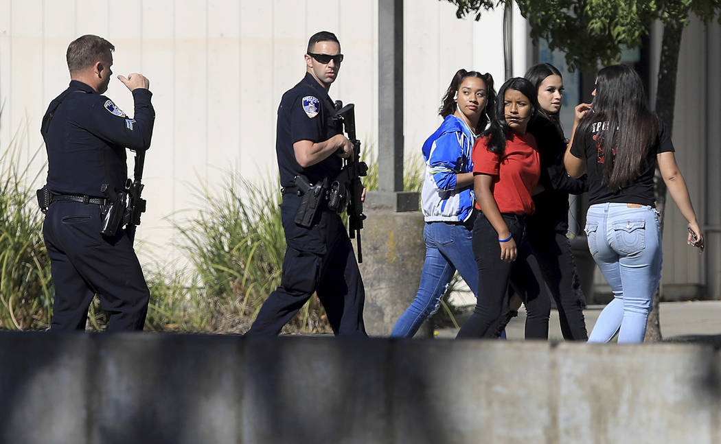 Ridgeway High School students are led back to their classes after the arrest of a suspect who o ...