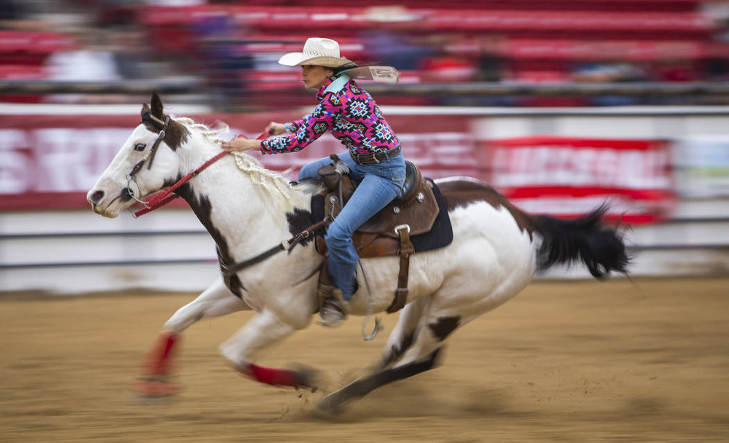 Barrel racer Karlee Meyers readies to turn her horse on the final barrel during the first round ...