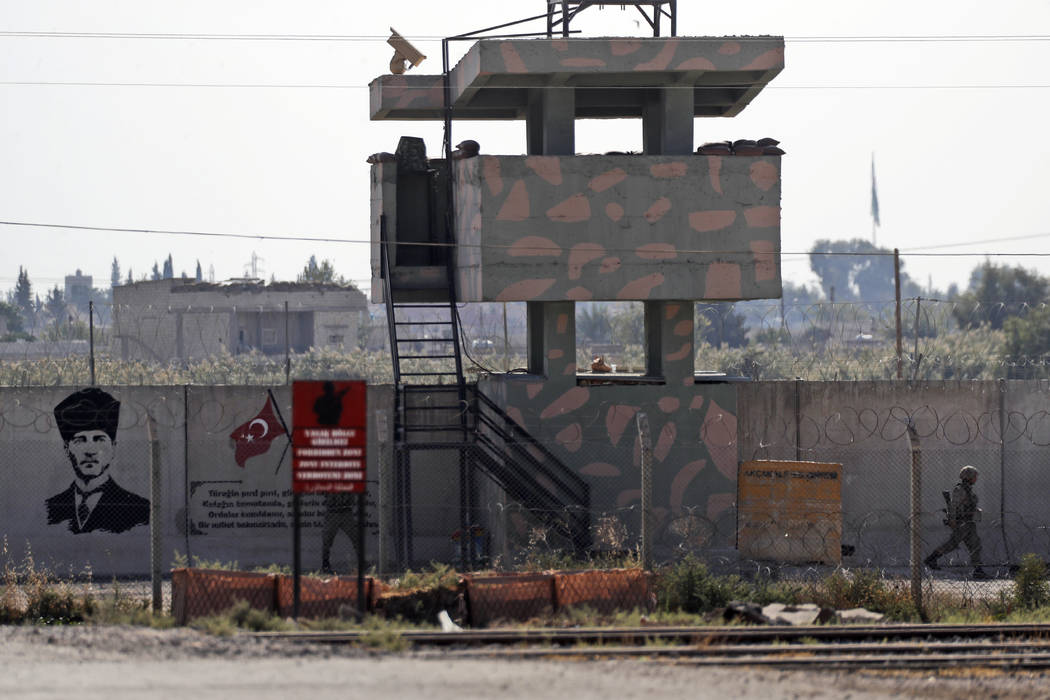 A Turkish soldier mans an outpost at the border with Syria in Akcakale, Sanliurfa province, sou ...