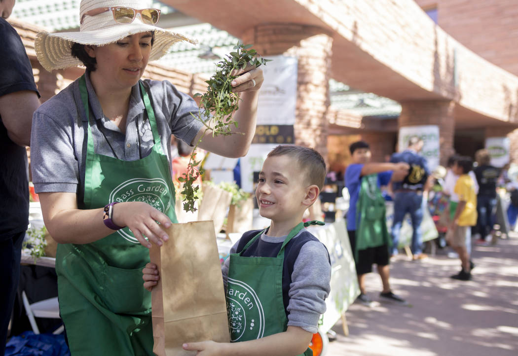 John C. Bass Elementary teacher Marin Mitchell, left, and her son Micah Mitchell, 6, bag fresh ...