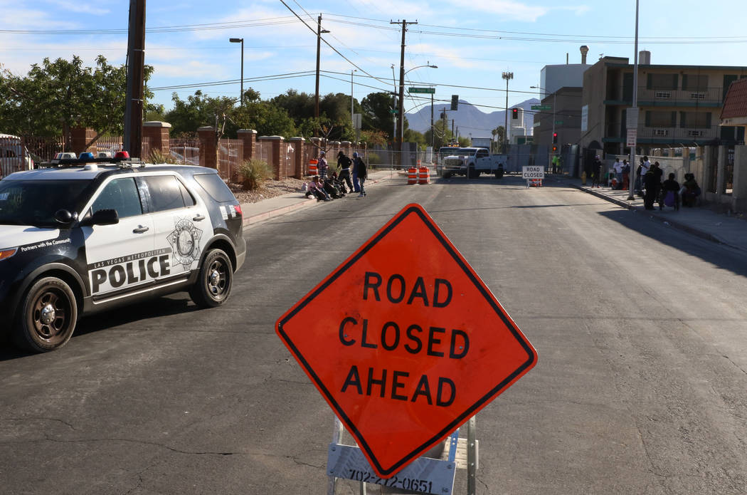 Road closure sign is seen as clients hangout outside the Courtyard Homeless Resource Center on ...