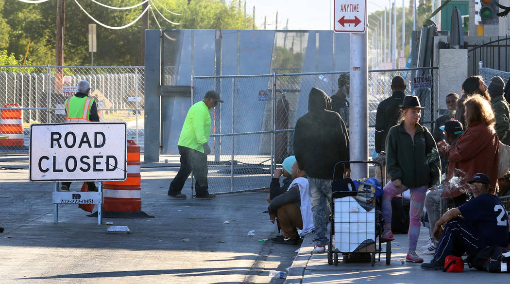 Road closure sign is seen as clients hang out outside the Courtyard Homeless Resource Center on ...