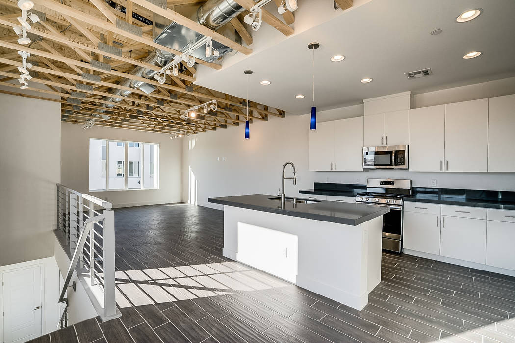 Paragon Lofts features stainless steel appliances, quartz countertops and exposed rafters in th ...