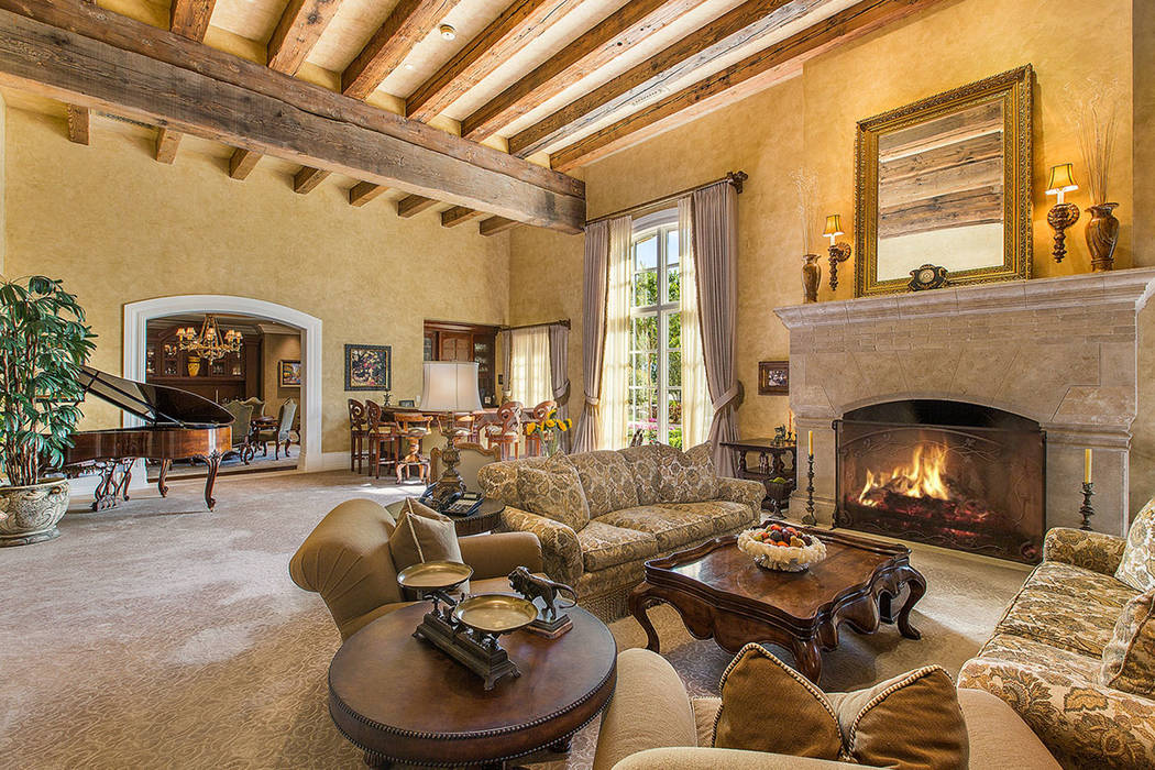 Fraser Almeida /Luxury Home Photography The living room has a traditional fireplace.