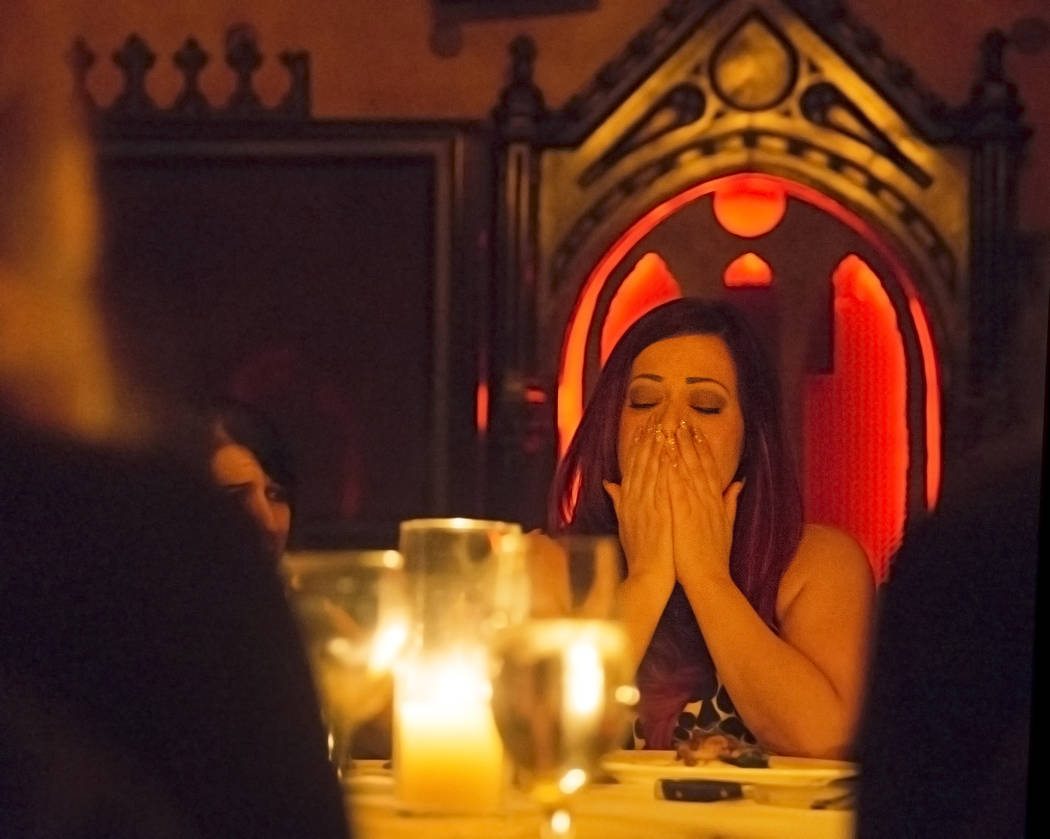 Rebecca Love reacts to a reading by psychic medium Thomas John during Dinner with the Dead on F ...