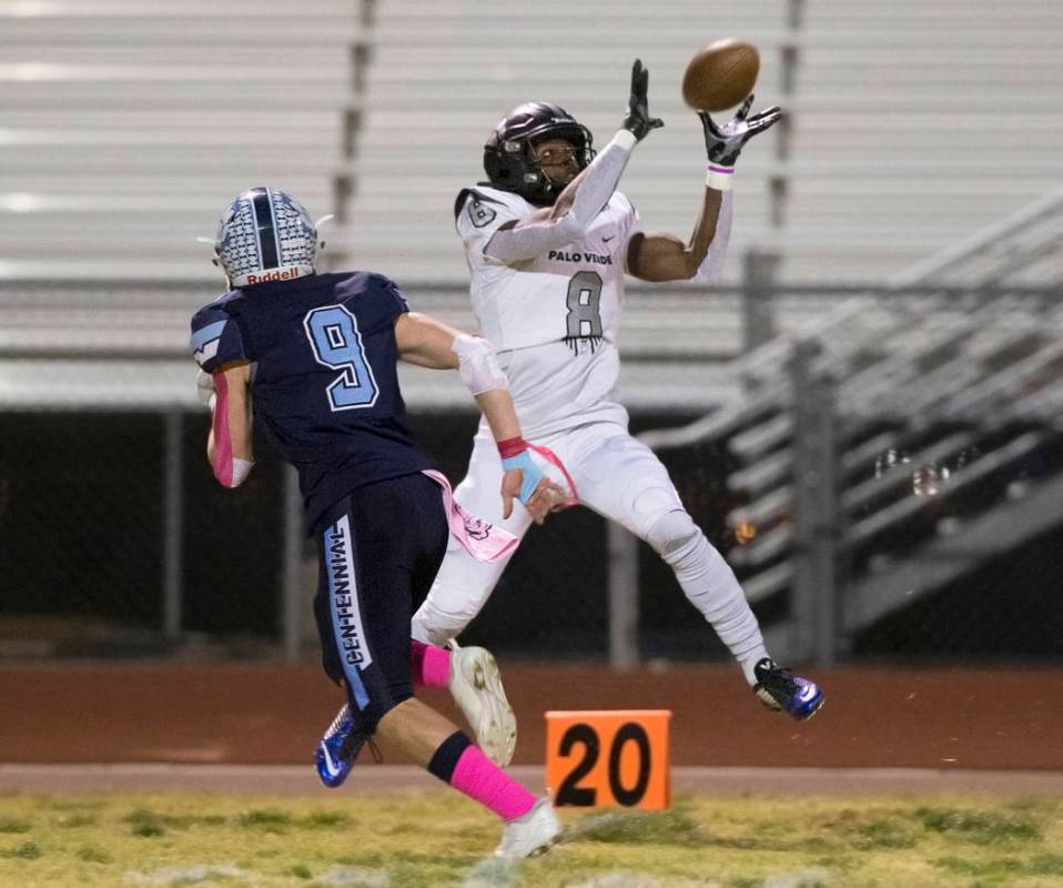 Palo Verde junior Adrian Ellis (8) pulls in a catch down the far sideline over Centennial senio ...