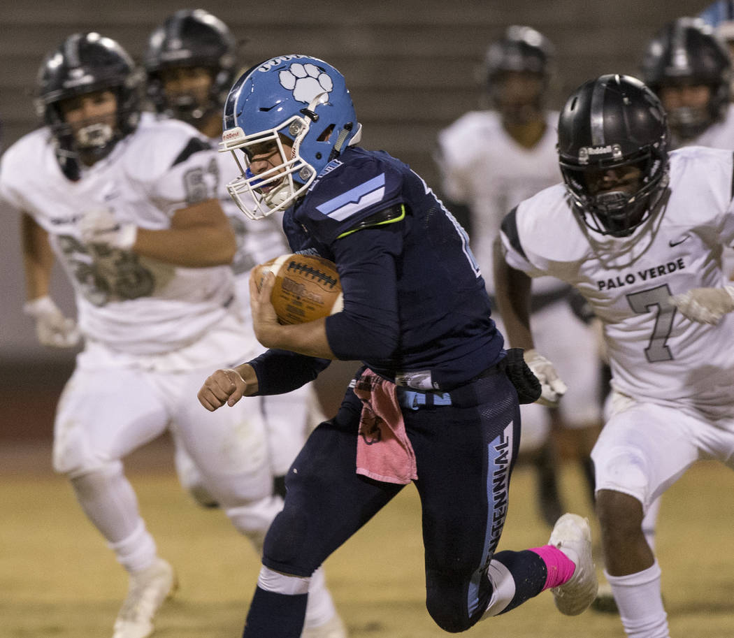 Centennial junior Colton Tenney (10) scrambles past Palo Verde senior Jayleen Mosley (7) in the ...