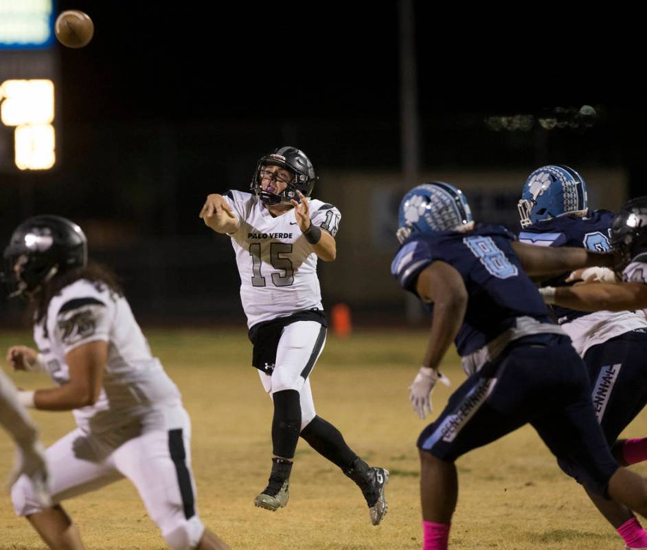 Palo Verde senior quarterback Paul Myro (15) makes a running throw over Centennial senior Thoma ...