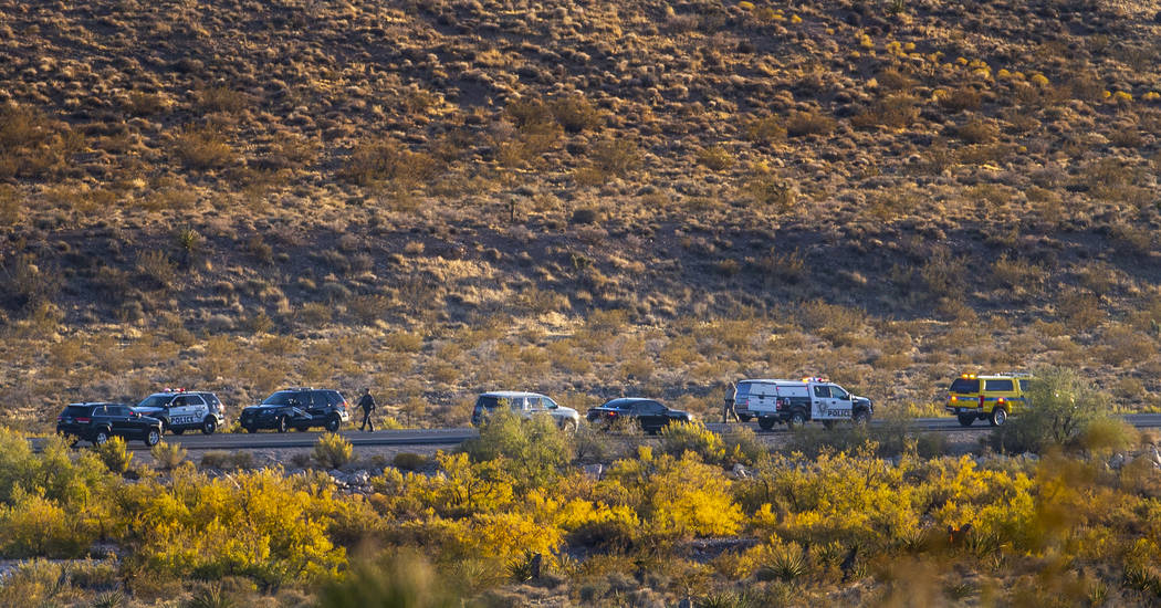 Emergency vehicles line state Route 159 in response to a helicopter crash in the Red Rock Conse ...