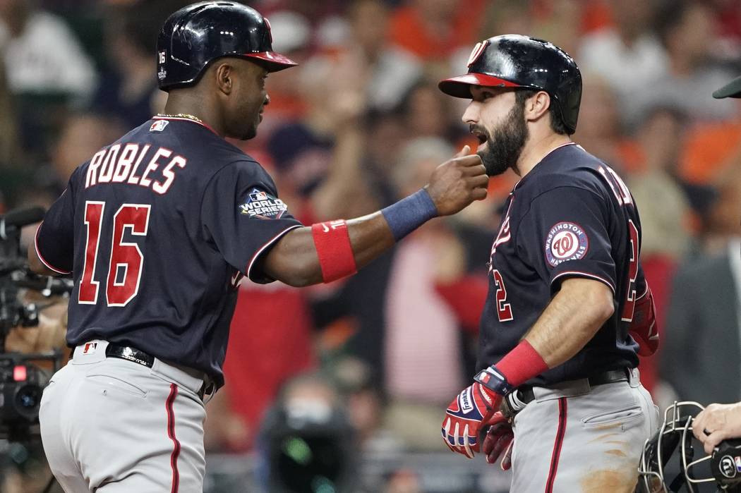 Washington Nationals' Adam Eaton is congratulated by Victor Robles after hitting a two-run home ...