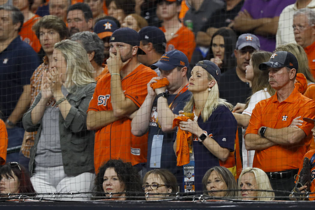 Fans watch during the seventh inning of Game 2 of the baseball World Series between the Houston ...