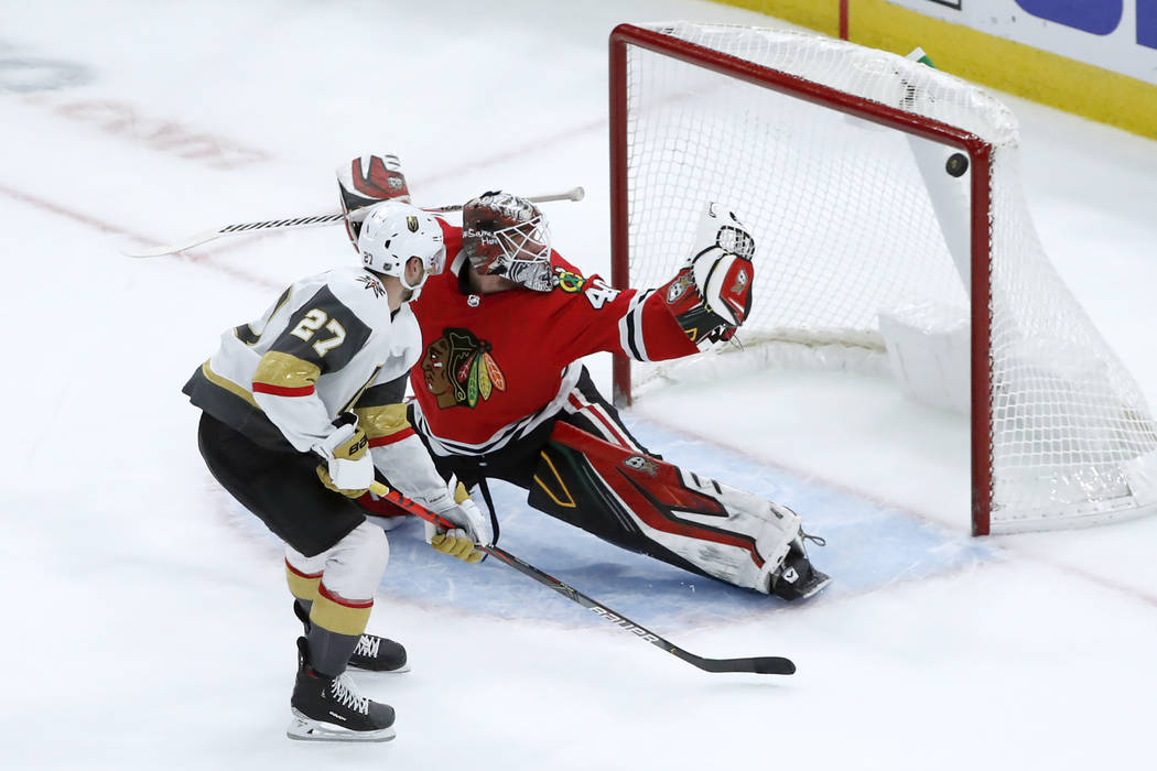 Vegas Golden Knights defenseman Shea Theodore (27) scores past Chicago Blackhawks goaltender Ro ...