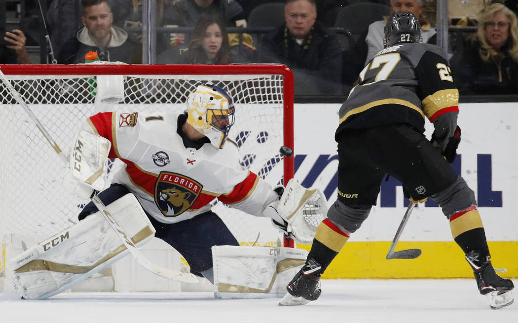 Vegas Golden Knights defenseman Shea Theodore (27) scores on Florida Panthers goaltender Robert ...