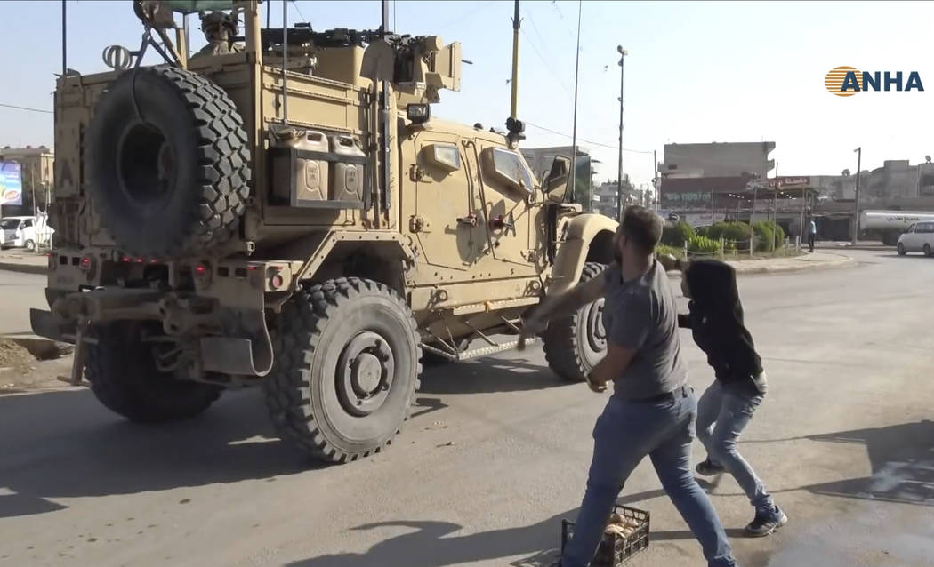 In this frame grab from video provided by Hawar News, ANHA, the Kurdish news agency, residents ...