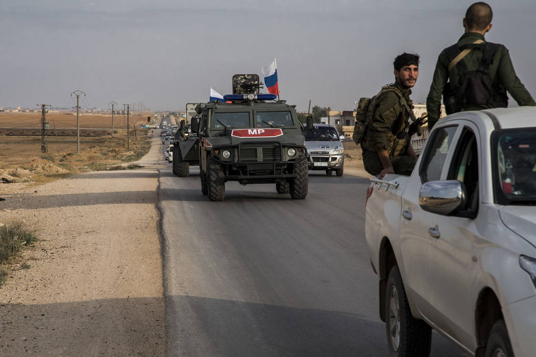 Russian forces patrol near the city of Qamishli, north Syria, Thursday, Oct. 24, 2019. Syrian f ...