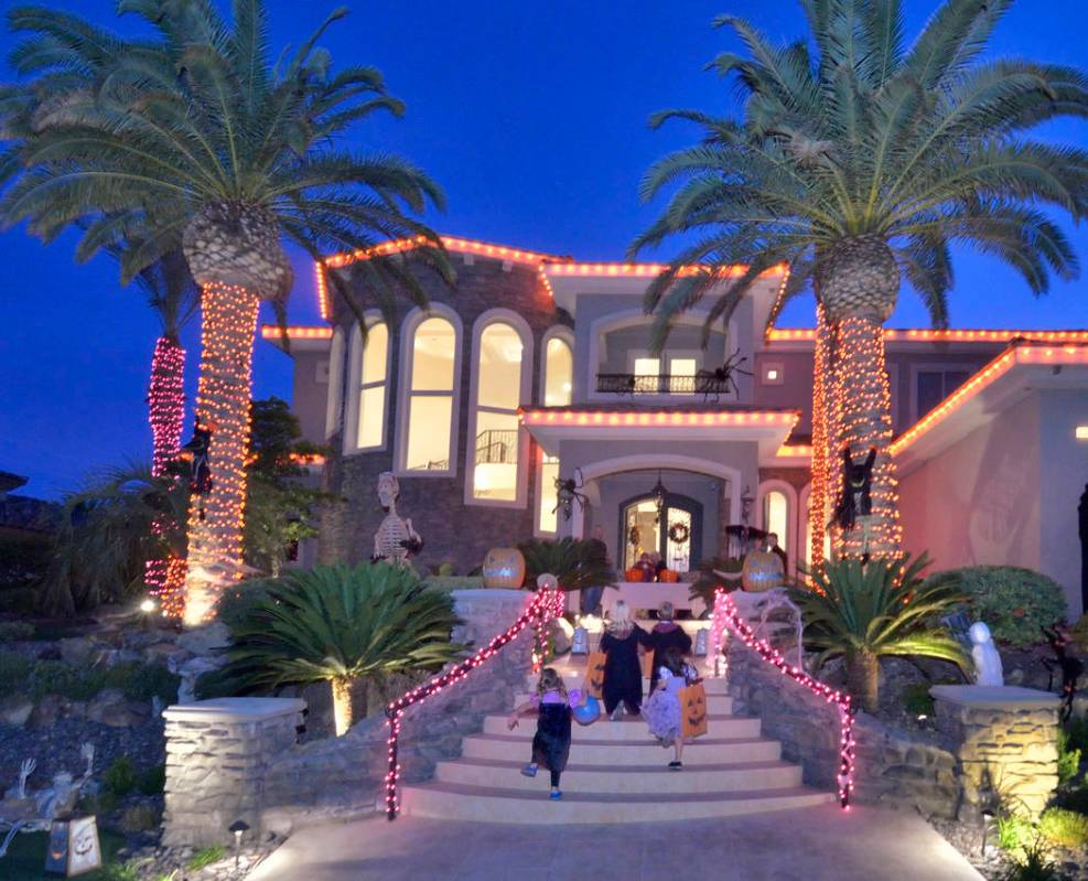 Trick-or-treaters climb the stairs to a Red Rock Country Club home. (Bill Hughes Real Estate Mi ...