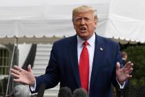 President Donald Trump talks to reporters on the South Lawn of the White House in Washington, F ...