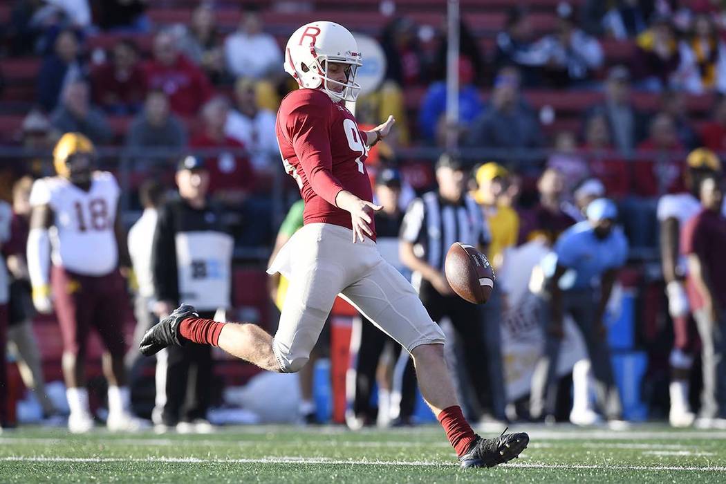 Rutgers punter Adam Korsak (94) kicks the ball during the first half of an NCAA college footbal ...