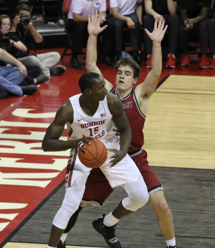 UNLV's forward Cheickna Dembele (15) looks for an opening as West Coast Baptist guard Sam Rumle ...