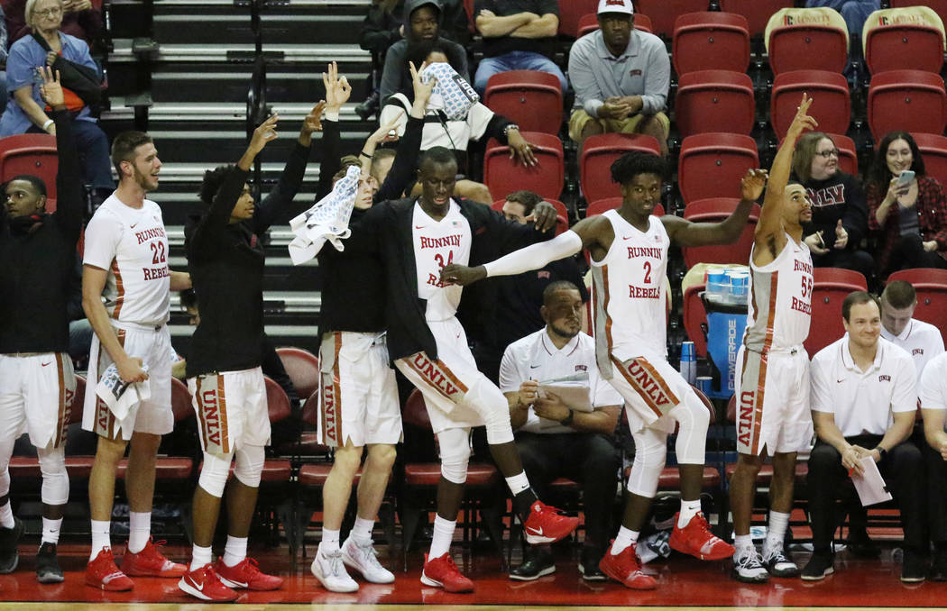 UNLV basketball players cheer for their teammates during the second half of their exhibition ga ...