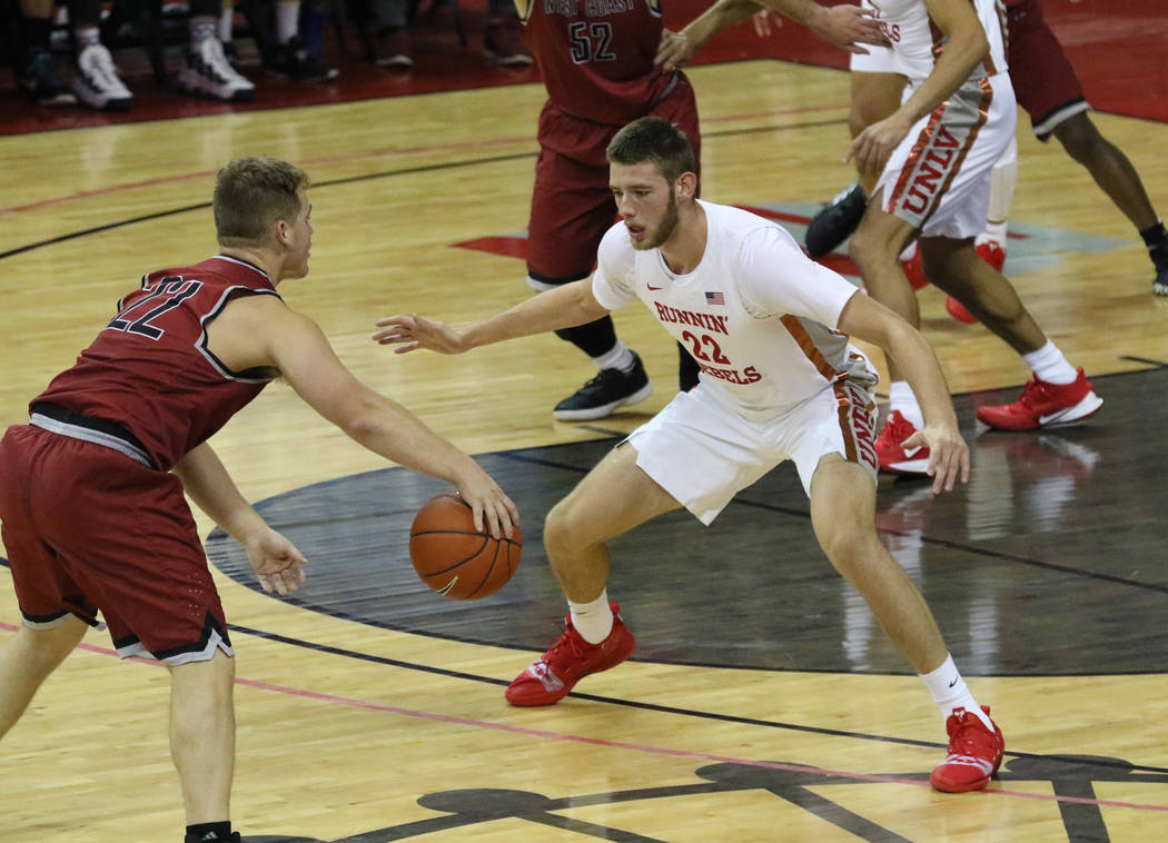 UNLV's guard Vitaliy Shibel (22) defends West Coast Baptist guard Seth Thomas Hanna (22) during ...