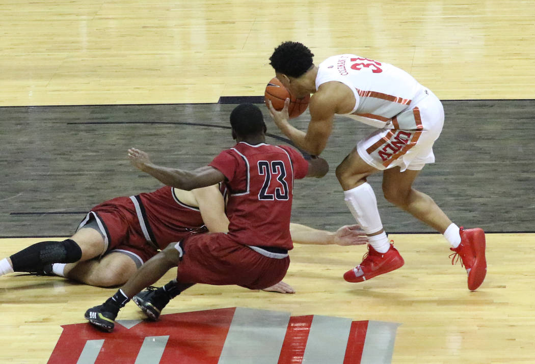 UNLV's guard Marvin Coleman (31) fights for a loose ball against West Coast Baptist guard Josep ...
