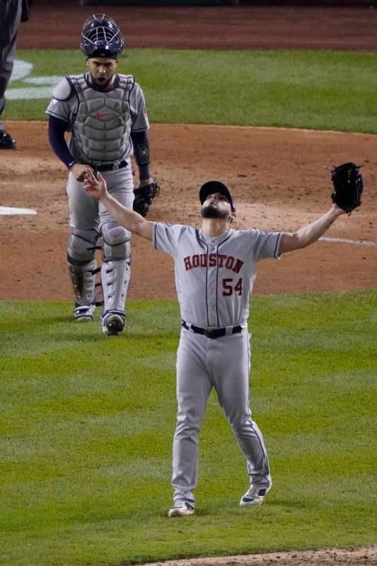 Houston Astros' Roberto Osuna and and Robinson Chirinos celebrate after Game 3 of the baseball ...