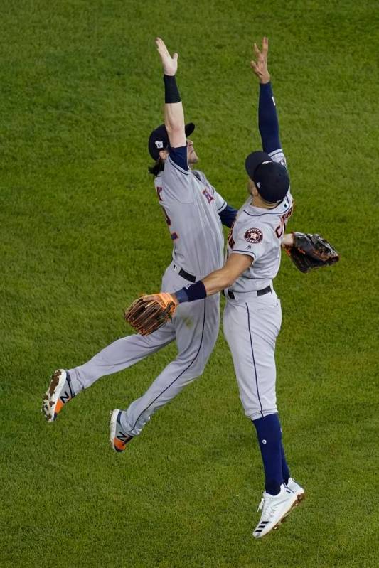 Houston Astros' Carlos Correa and Josh Reddick celebrate after Game 3 of the baseball World Ser ...