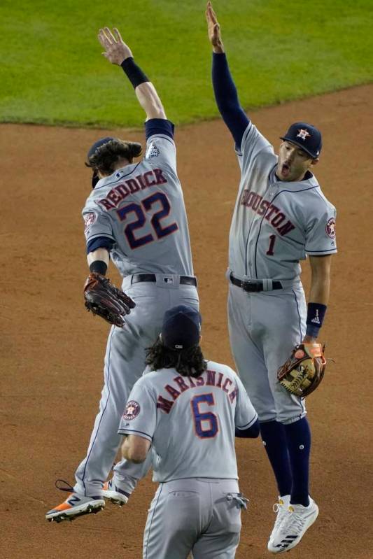 Houston Astros' Carlos Correa and Josh Reddick celebrate after Game 3 of the baseball World Ser ...