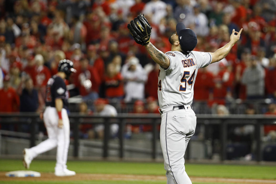 Houston Astros relief pitcher Roberto Osuna celebrates their teams win against the Washington N ...