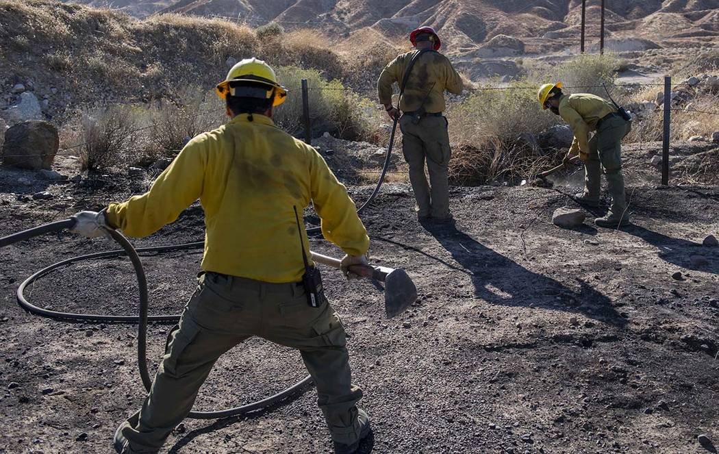 An engine crew looks for any remaining hot spots from the Tick Fire, Thursday, Oct. 25, 2019, i ...