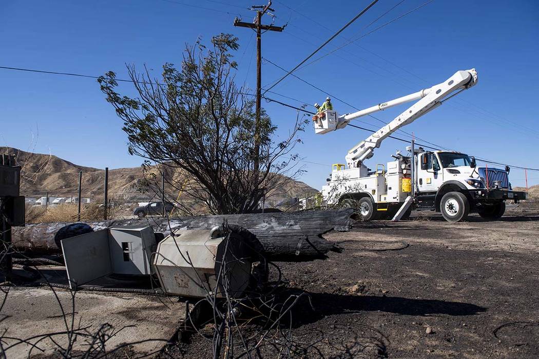 SoCal Edison workers replace power lines that were damaged from the Tick Fire, Thursday, Oct. 2 ...