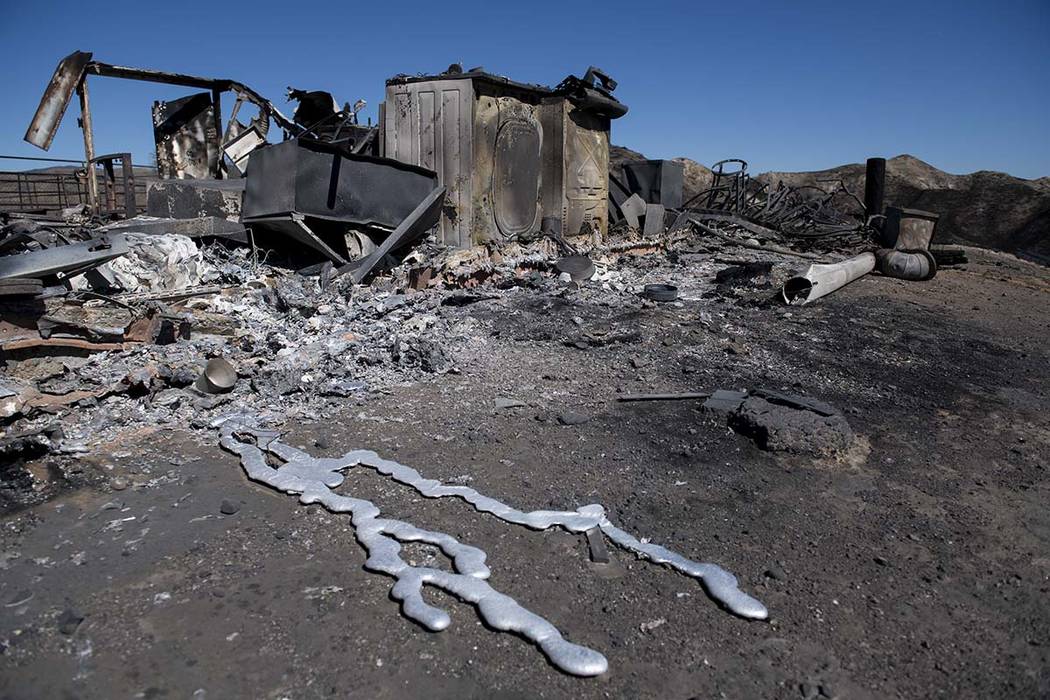 Debris from a hilltop home smolders after being burned by the Tick Fire, Thursday, Oct. 25, 201 ...