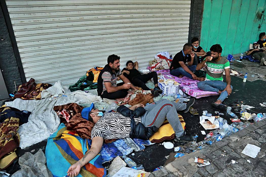 Anti-government protesters rest during sit-in at Tahrir Square in Baghdad, Iraq, Saturday, Oct. ...