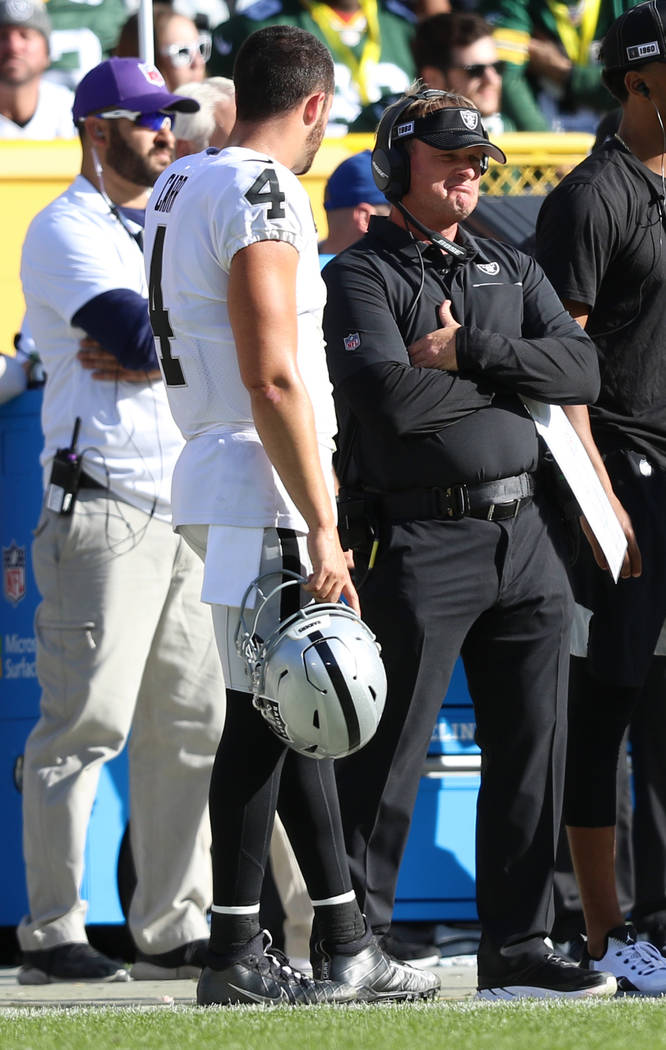 Oakland Raiders quarterback Derek Carr (4) speaks to head coach Jon Gruden on the sideline duri ...