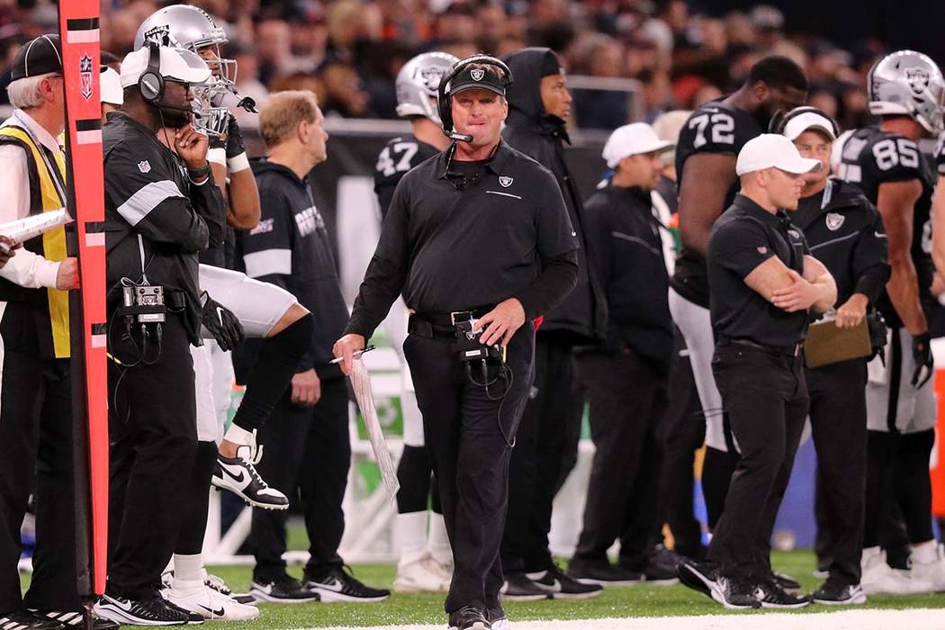 Oakland Raiders head coach Jon Gruden walks the sideline during the first half of an NFL game a ...