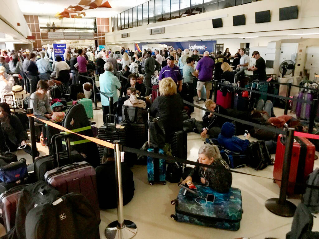 Crowds form at Louis Armstrong New Orleans International Airport after the remnants of Tropical ...