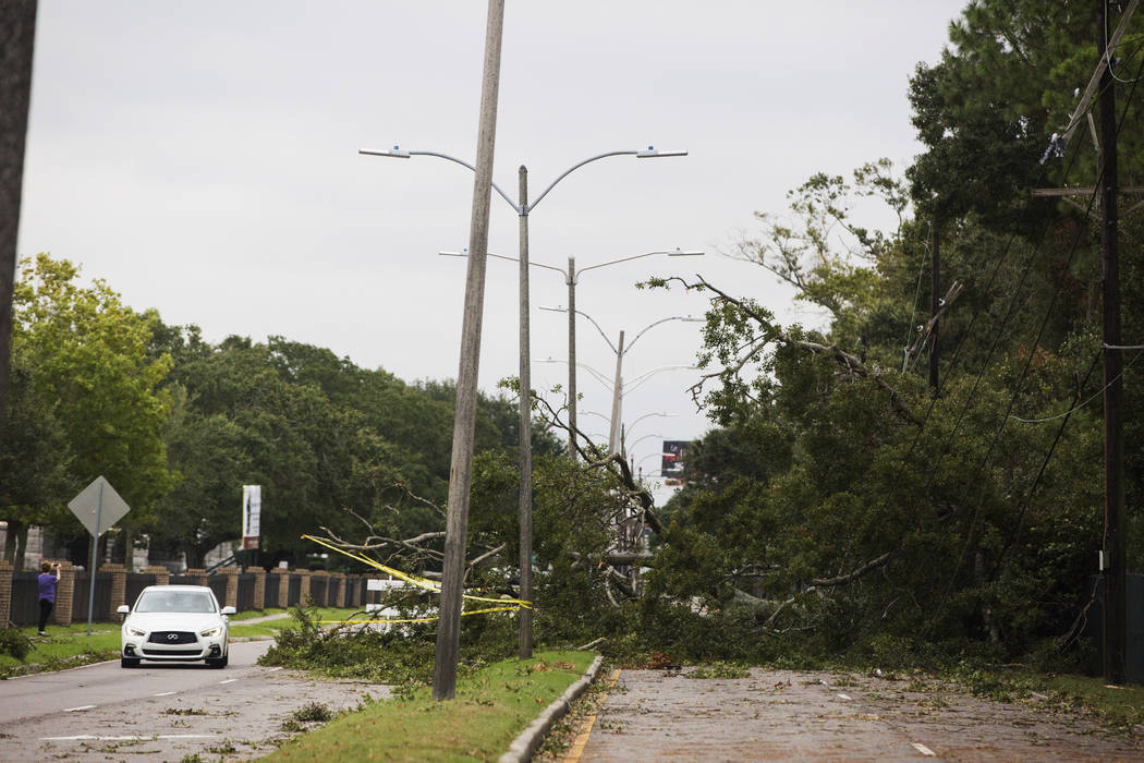 A tree falls on Metairie Road and takes out power lines in New Orleans on Saturday, Oct. 26, 20 ...