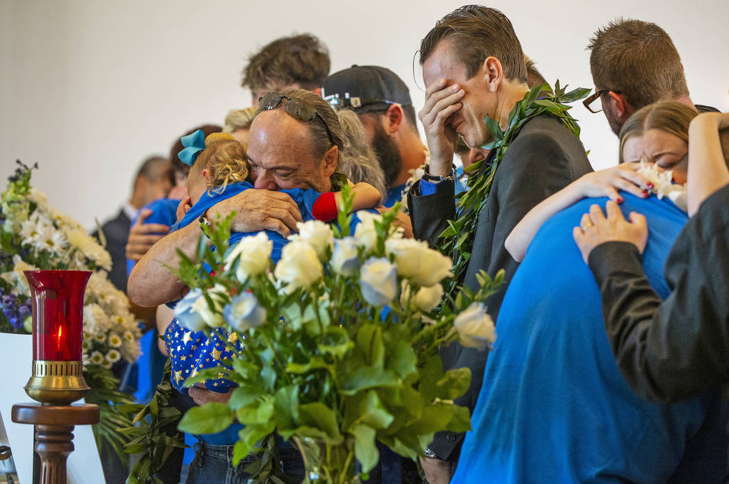 Sean Murray, center, weeps before the urn of his son Gavin Murray, 6, while surrounded by fami ...