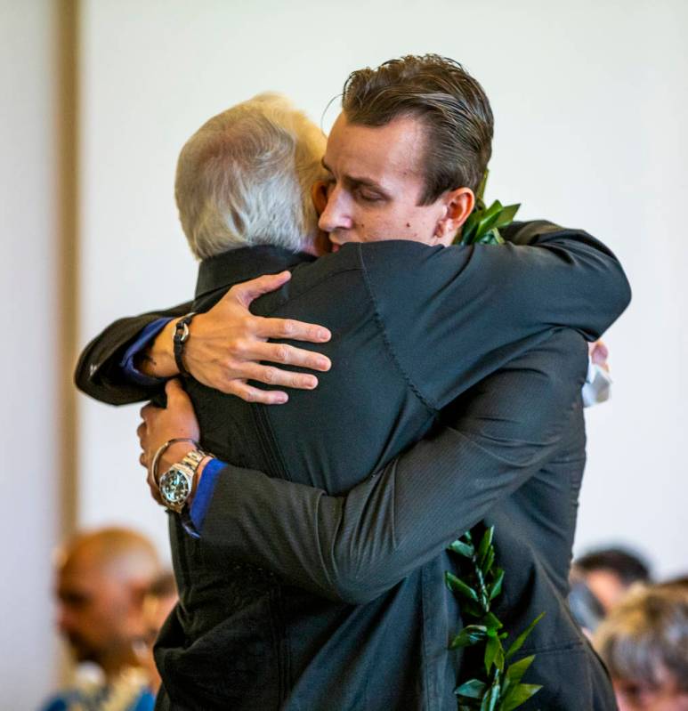 Sean Murray, right, is hugged by his father, Gordon Murray, during a funeral service for his s ...