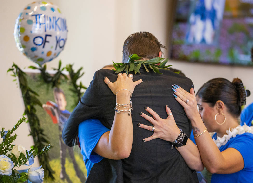 Sean Murray, center, is comforted by family members before the urn of his son, Gavin Murray, 6, ...