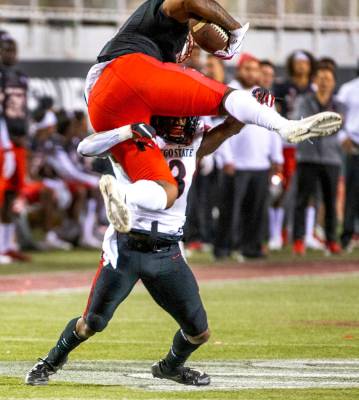 UNLV Rebels tight end Noah Bean (11, above) attempts to go over San Diego State Aztecs cornerba ...