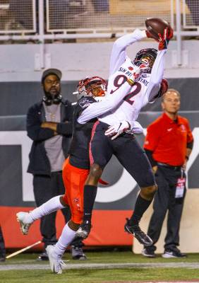 UNLV Rebels defensive back Myles Plummer (14) attempts to break up a pass to San Diego State Az ...