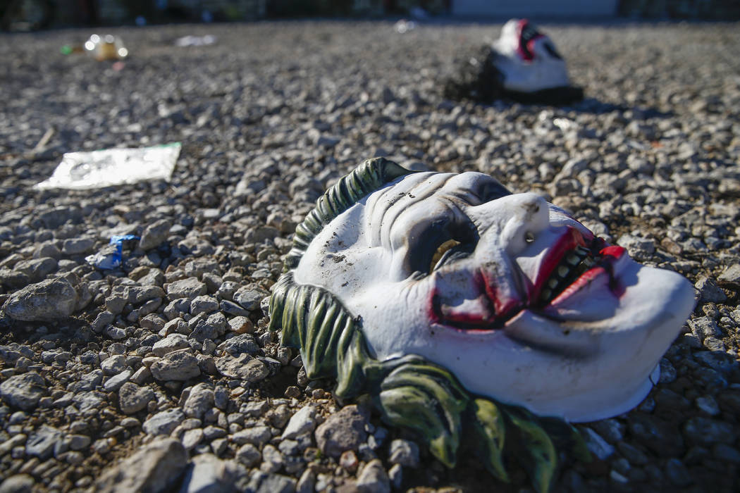 Halloween masks litter the ground amongst signs of chaos at the scene where a mass shooting occ ...