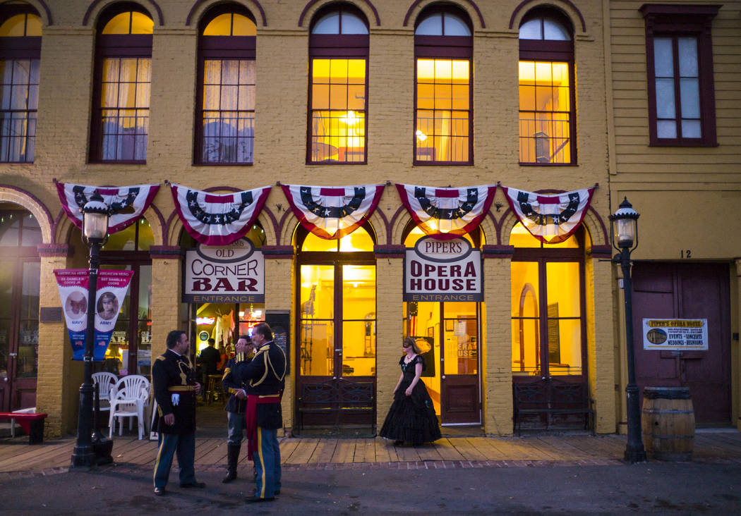 Attendees in period outfits chat outside Piper's Opera House before the start of the Nevada Sta ...